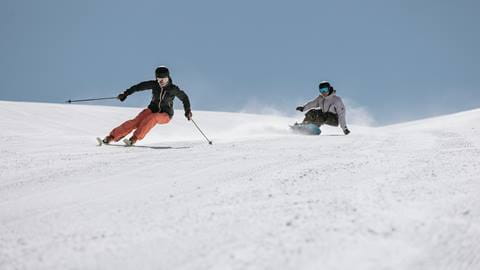 Skier and snowboarder on June Mountain
