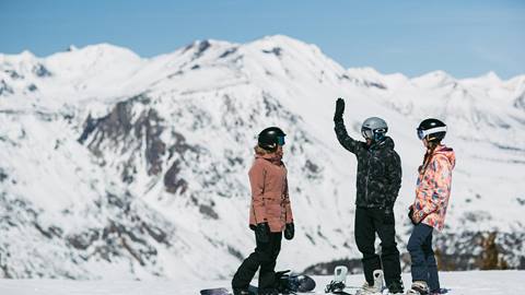 friends high fiving on a hill