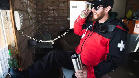 ski patrol employee on the phone